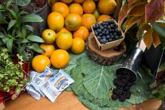 A photo of stacks of oranges and blueberries